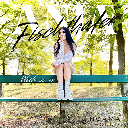 Portrait of a woman sitting on a green park bench under sunny trees, with large cursive text across the image and a logo at the bottom-right (album cover style).